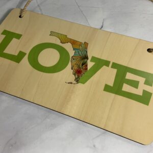 Wood sign with Love FL outline and beach scene