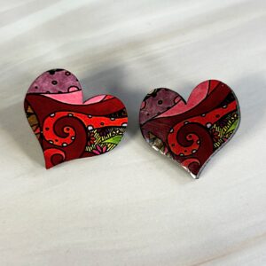 Heart shaped stud earrings, pink/green abstract swirl pattern